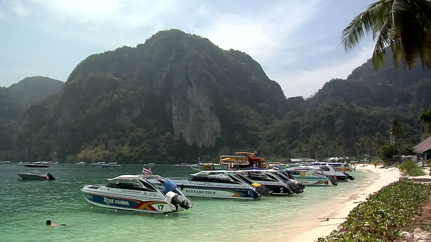 PHI PHI ISLAND, THAILAND - CIRCA FEBRUARY 2009: Motor Boats on Ao Loh Da Lam Beach