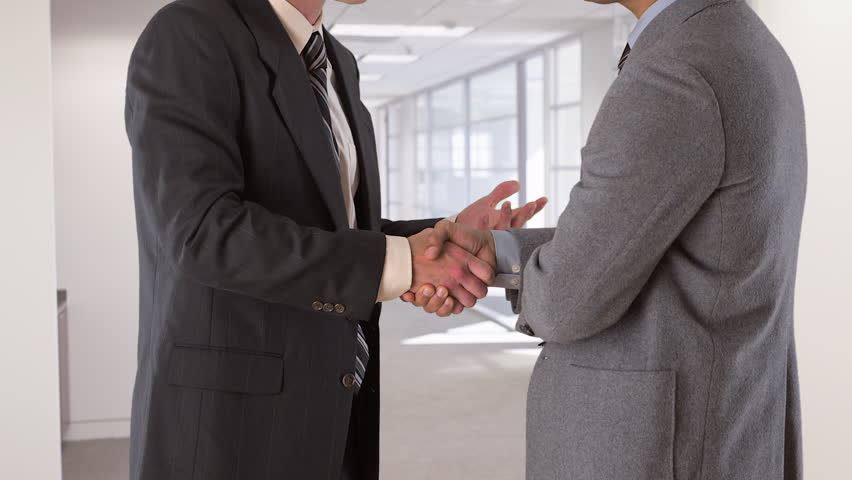 two businessmen shake hands