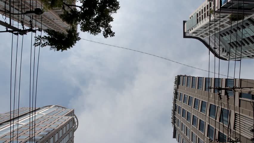 High-angle view motion-jib shot of skyscrapers in downtown of big city.
Street to sky tracking car rig mouth shot of modern office buildings in Bangkok Thailand.
