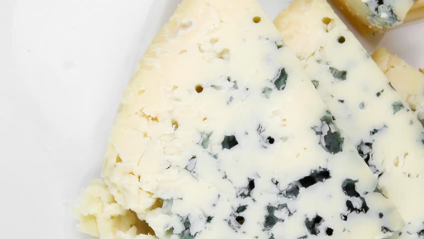 french delicatessen aged cheeses chops served on white plate with slices hidef intro slow motion
