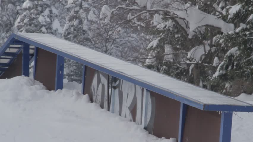 Snowboarder sliding down the rail