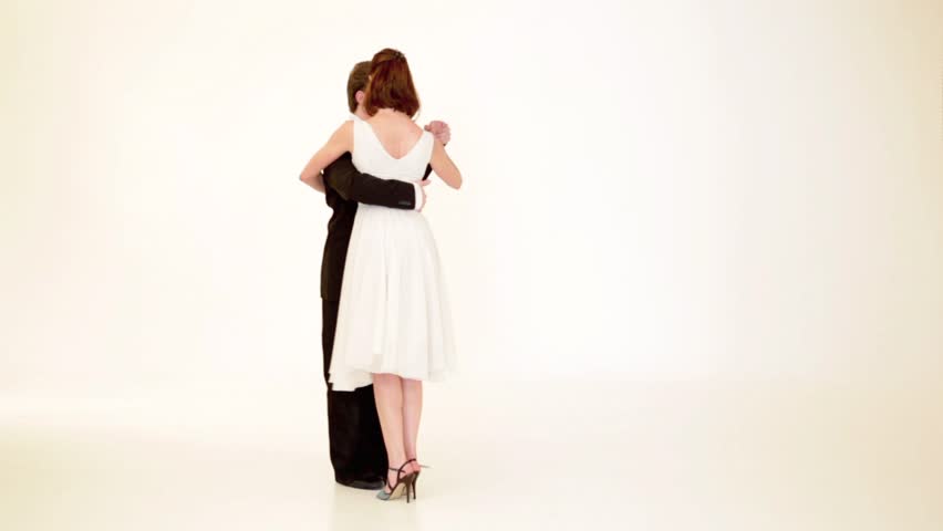 passionate, young couple showing dance moves on white background