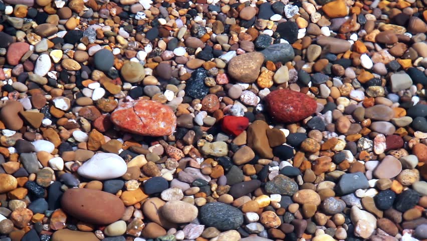 Seamless loop features waves over colorful beach pebbles in shallow water. Shot on the Indiana coast of Lake Michigan at 1920x1080p HD widescreen.