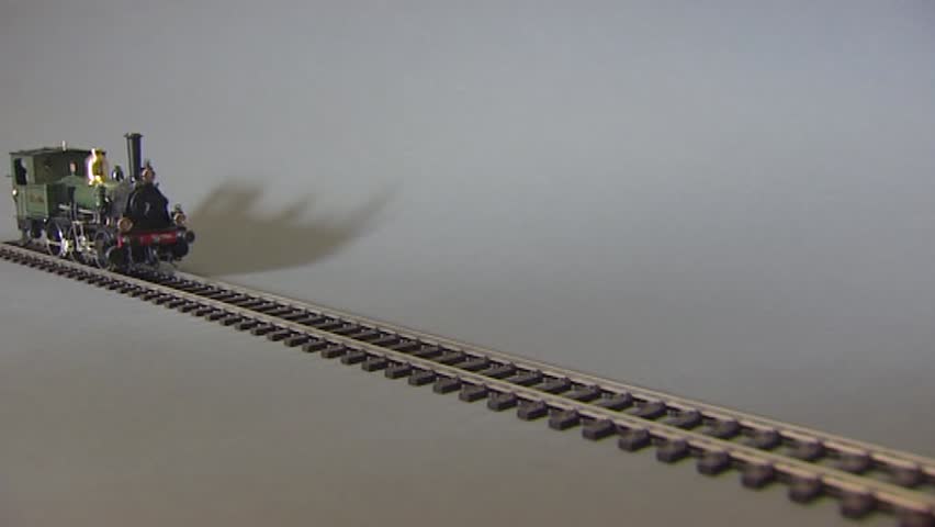 model train runs forward towards camera stops and runs backwards