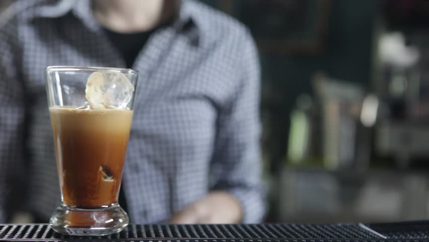 Preparing a cold espresso coffee at the bar