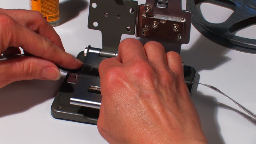 Close-up of 16mm film being spliced.