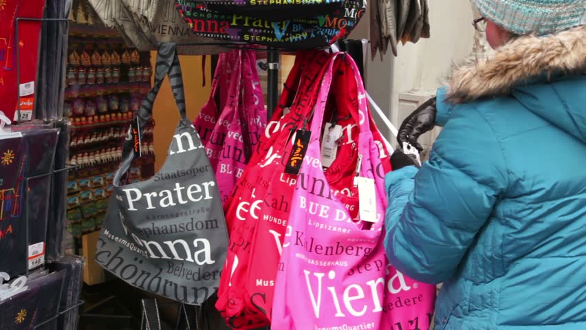 VIENNA- FEB 19: woman chooses bag in shop souvenirs on Feb 19, 2011, Vienna, Austria. Many shops and shopping centers are located in Vienna which offer large number of various qualitative production