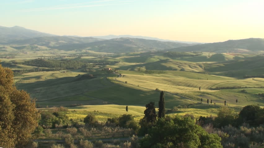 Pan of Val d'Orcia in the province of Siena in Tuscany, Italy at sunset