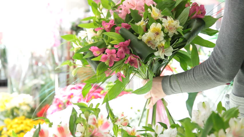 Young Female Florist Arranging Bouquet Of Alstroemeria In Her Store Closeup
