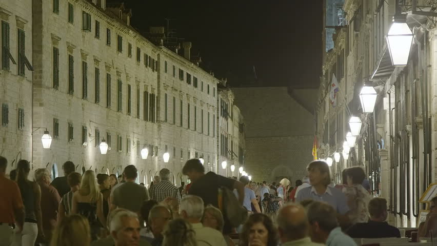 DUBROVNIK, CROATIA - SEPTEMBER 3 2012 - Summer atmosphere with tourists sightseeing and movement around cafe bars in the old town main street Placa on September 3, 2012. in Dubrovnik, Croatia.