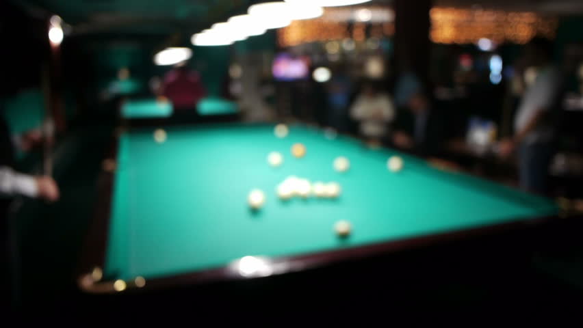 Playing russian billiard in a poolroom, defocused view