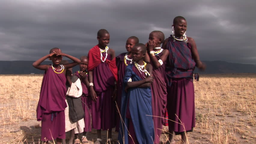 African brother and sister deprived children in a village. Storm sky.