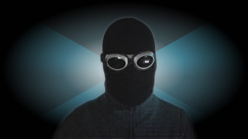 video of computer pirate holding credits cards in front of a futuristic background with a scanning effect over his silhouette and red computer data