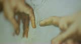 Racking close up of The Creation of Adam