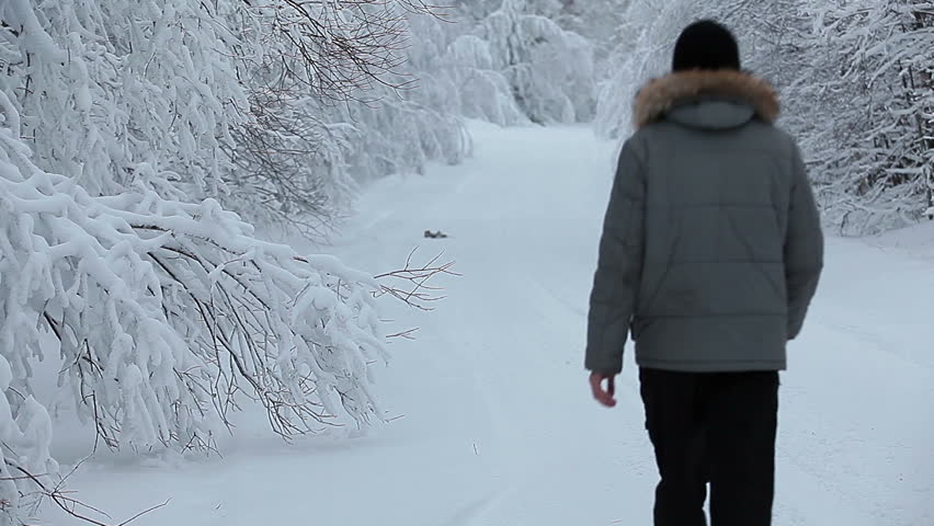 One Caucasian male going away along winter road