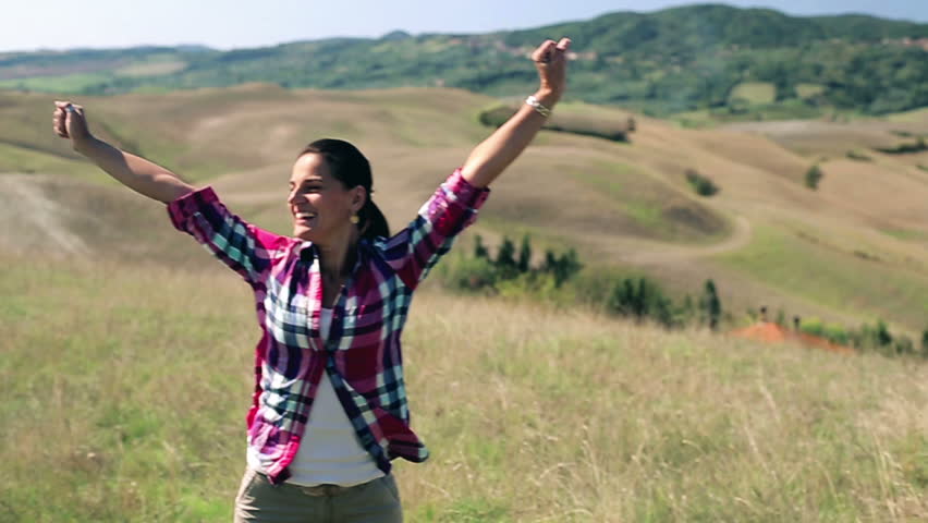 Young woman enjoying panoramic view of Tuscany, slow motion
