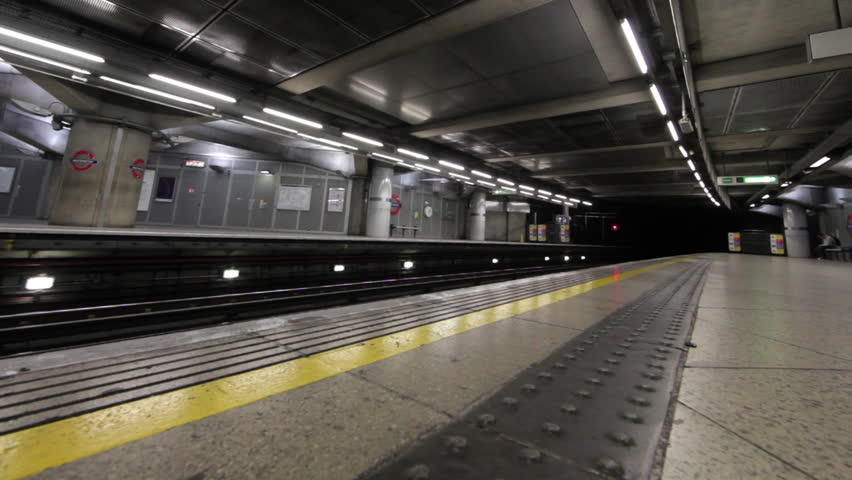 LONDON - OCTOBER 9, 2011: Passengers exit train as train stops at underground train station 