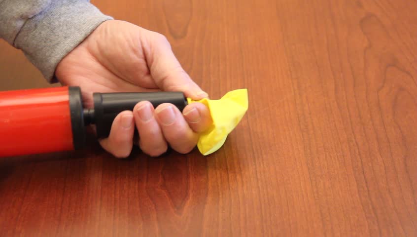 blowing up a balloon with a hand pump