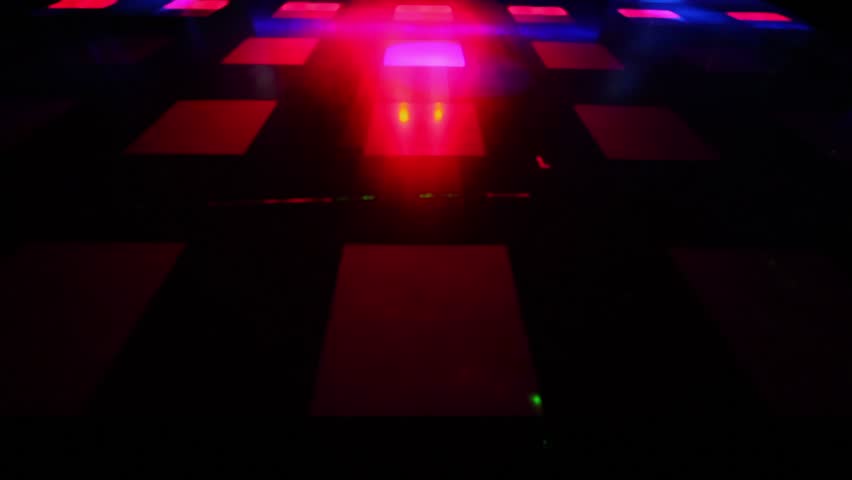 Light spots and laser beams moves on dance floor with squares