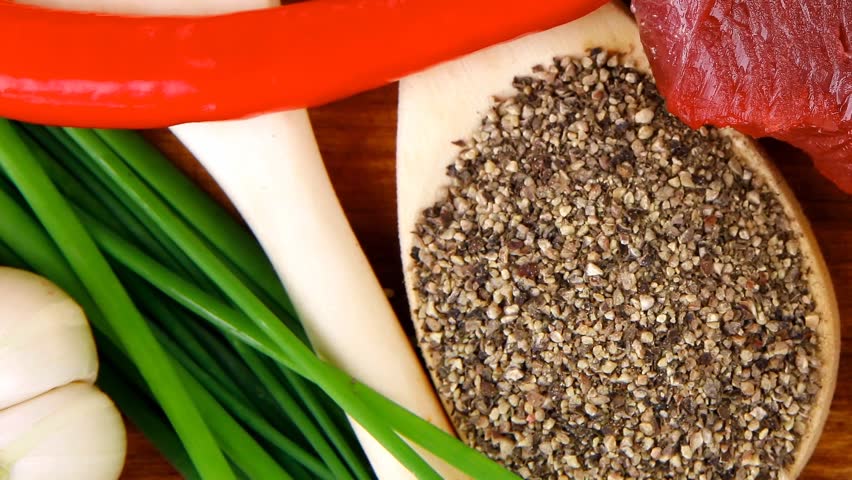 butchery : fresh raw beef lamb big rib ready to cooking with green stuff on wooden plate isolated over white background