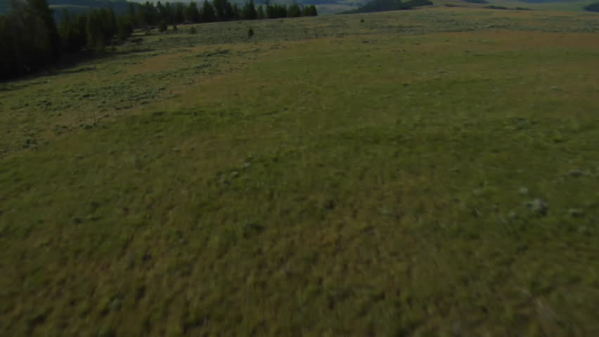 aerial shot of sagebrush pastureland with mountains