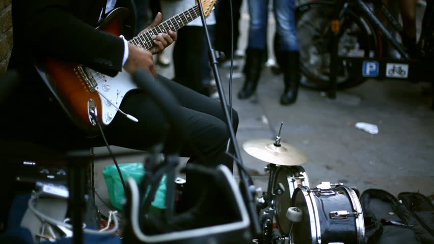 guitar player performing on street