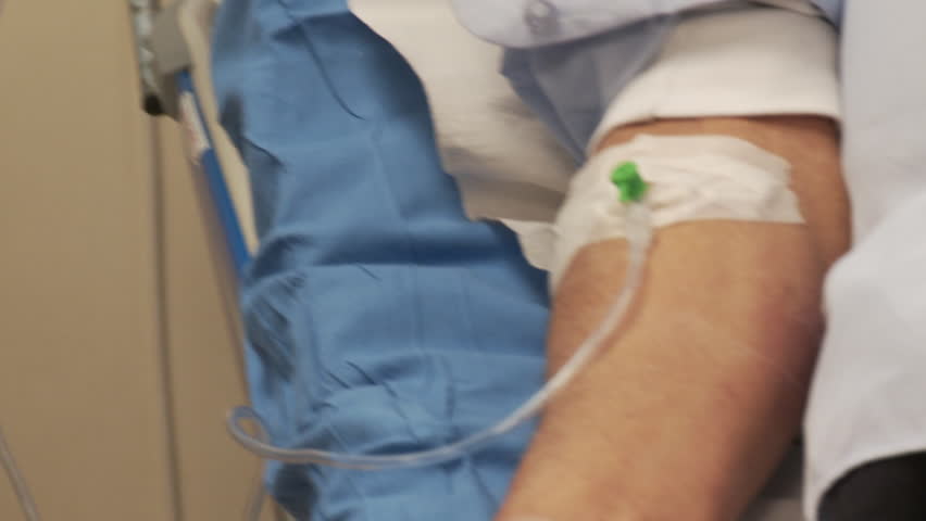 Hospital medical treatment including IV bag inserted to a patient 