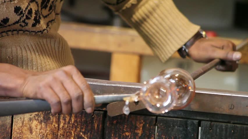 Working Glass In Murano, Italy - Video clip of artisan of glass creating a crystal vase - Murano, Venice, Italy.
