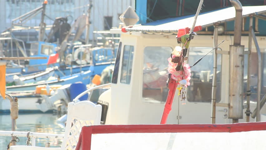 unique personal little boats anchored at Jaffa port and two women pass by in the back