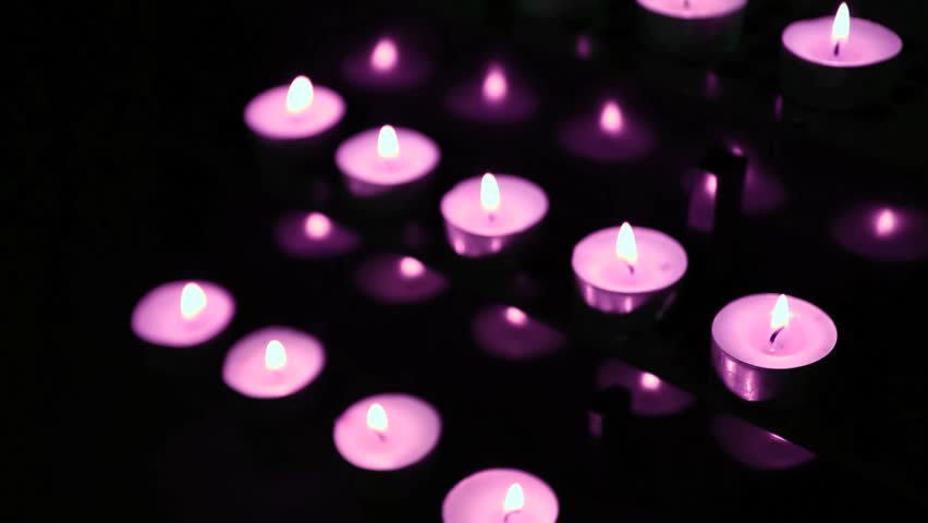 Pink candles at alter flickering and blowing out