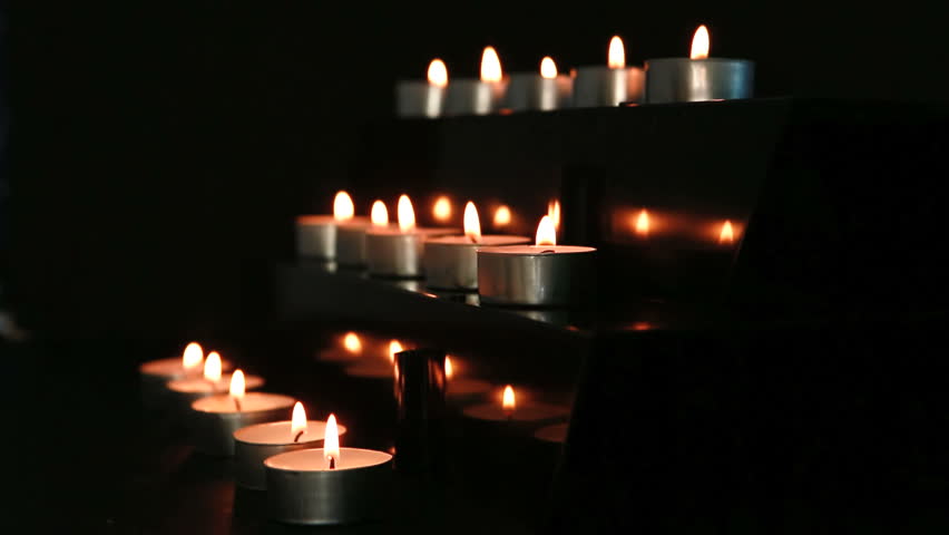 Candles at the alter flickering in the dark