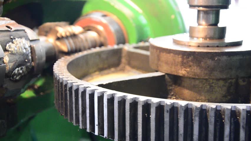  industrial machine for wormwheel gear and cogwheel production and service, rotating gears extreme closeup view
