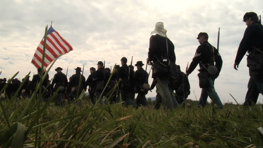 CHICKAMAUGA, GEORGIA - OCTOBER 2008 - Large-scale, epic Civil War anniversary reenactment -- in the middle of battle.  Union Army marches in column of infantry into battle from a low angle in the grass