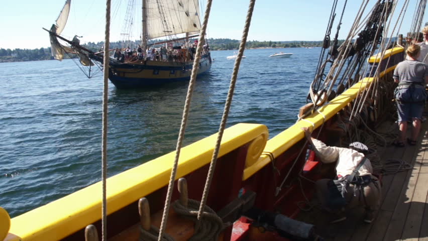 KIRKLAND, WASHINGTON - SEP 1 -Gunner fires & reloads a cannon on the Lady Washington 	  during a mock sea battle as part of Labor Day festivities on Sep 1, 2012 near Kirkland , Washington.

