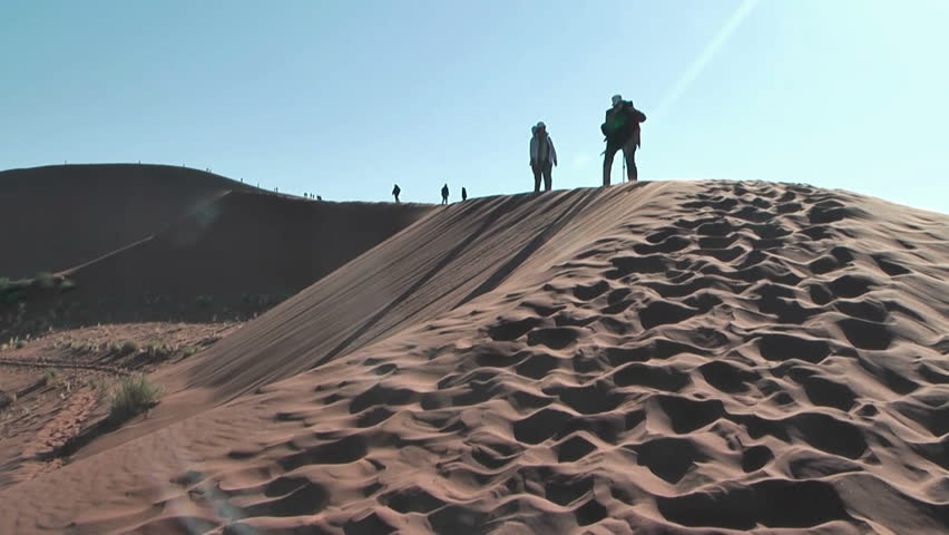 Photographer on big daddy dune,Soussuvlei,Namibia,Africa. Tourists are climbing up the dune.
