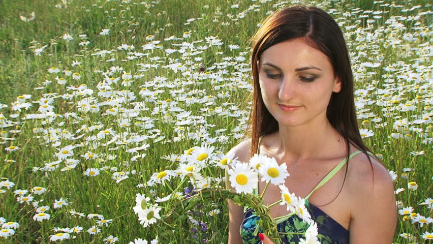 Woman wearing a wreath made of chamomiles.
Chamomile wreath.