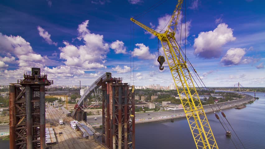 Crane unloads sand in the water. Time-lapse