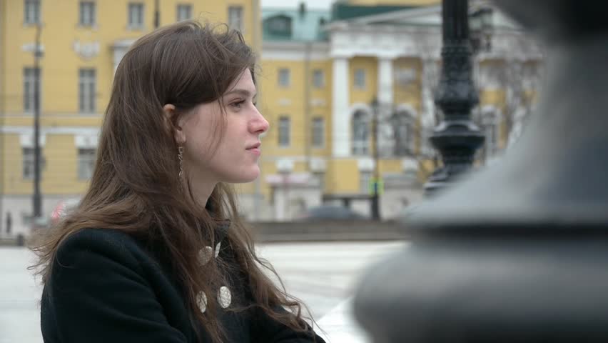 HD1080p25 Sexy woman in vintage fashion looks serious in town square