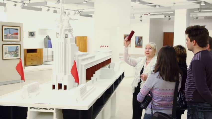 MOSCOW - DEC 10: People watch miniature of famous soviet monument during excursion in museum and exhibition center - Worker and Collective Farm Gir on december 10, 2011 in Moscow, Russia.