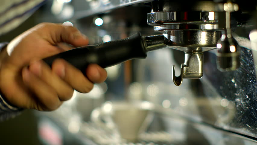 Barista makes two coffees in coffee bar     