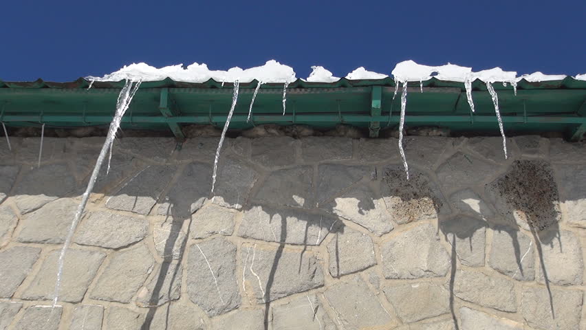 Long Melting Icicles on Roof of a Rural House, Snow and Icicles on Chalet Top