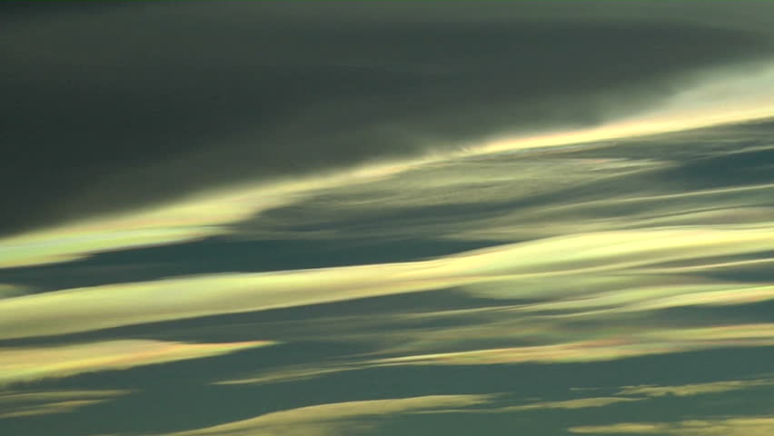 Multi-colored Waves. Mountain wave clouds exhibit iridescence, indicating they are composed of small liquid water droplets.
