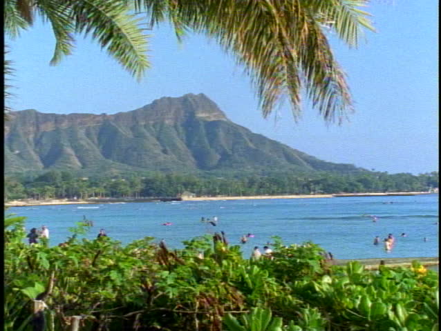 Diamond Head alone surrounded by green foliage, from Waikiki in Honolulu