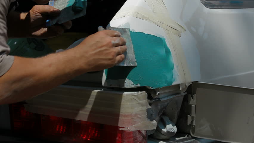 Smearing putty the damaged surface, car painting