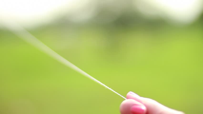 kite rope gets stretched sharply, as if the kite was taken up by the wind, close-up on hand and rope