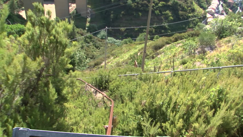 Rack-rail cart slowly making it's way down a hillside
