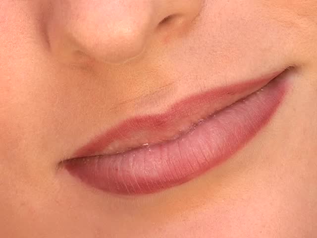 Make-up artist applying cosmetics to woman