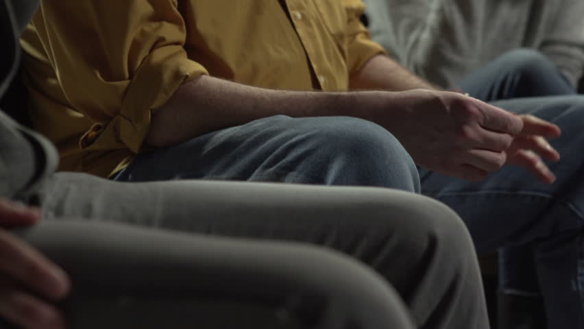 Man giving his testimony at a support group, crying