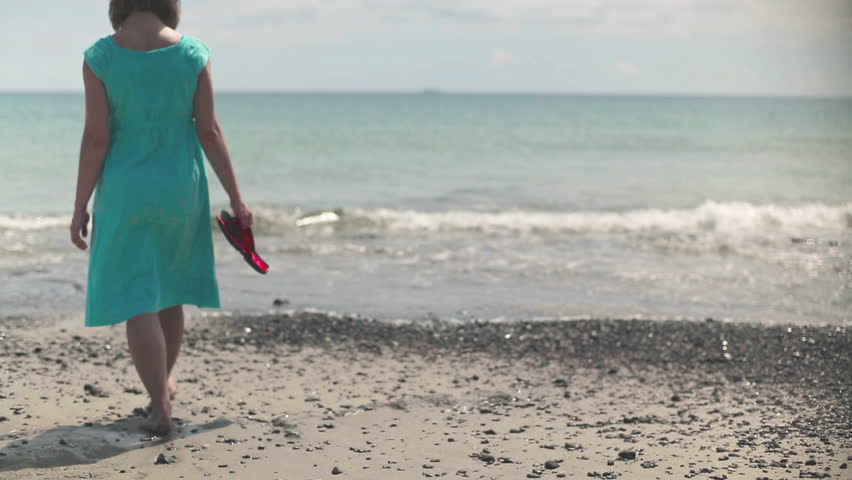 Young woman walking on the beach
