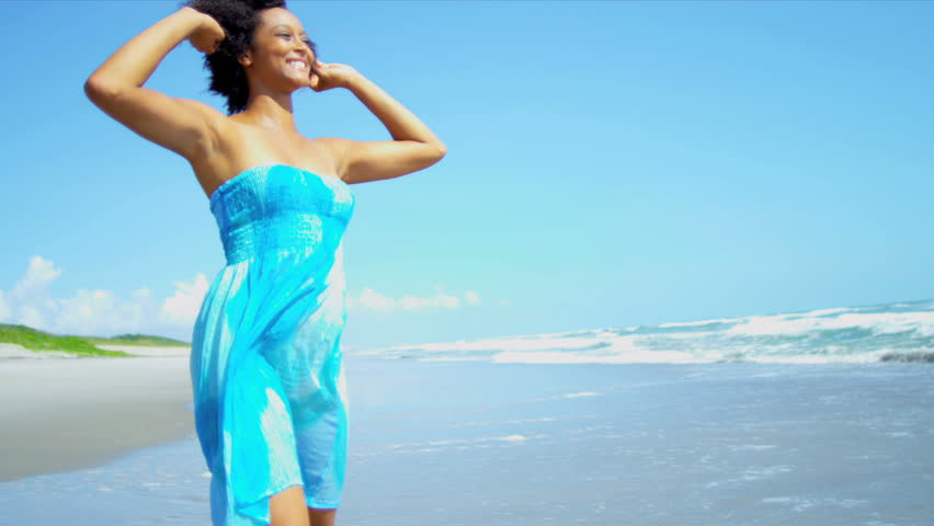 Pretty girl in sundress reveling being alone in ocean on beach vacation shot on RED EPIC